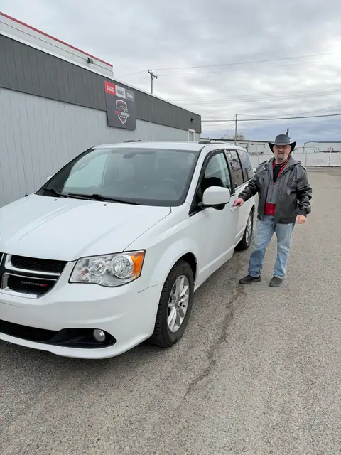 A Shift Happens Auto Sales customer with their 2020 Dodge Grand Caravan on handover day