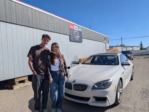 A Shift Happens Auto Sales customer with their vehicle on handover day